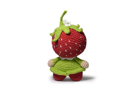 Finished Strawberry amigurumi on white backdrop.